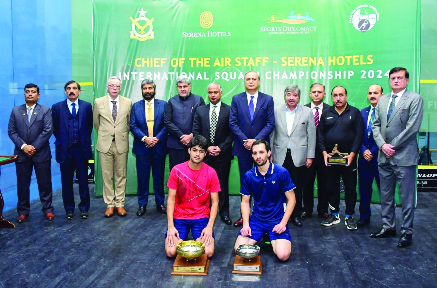 winner noor zaman of pakistan and runner up nasir iqbal are seen with their trophies as they pose with chief guest air marshal shakil ghazanfar former champion qamar zaman and other officials after the cas serena squash final on saturday photo app