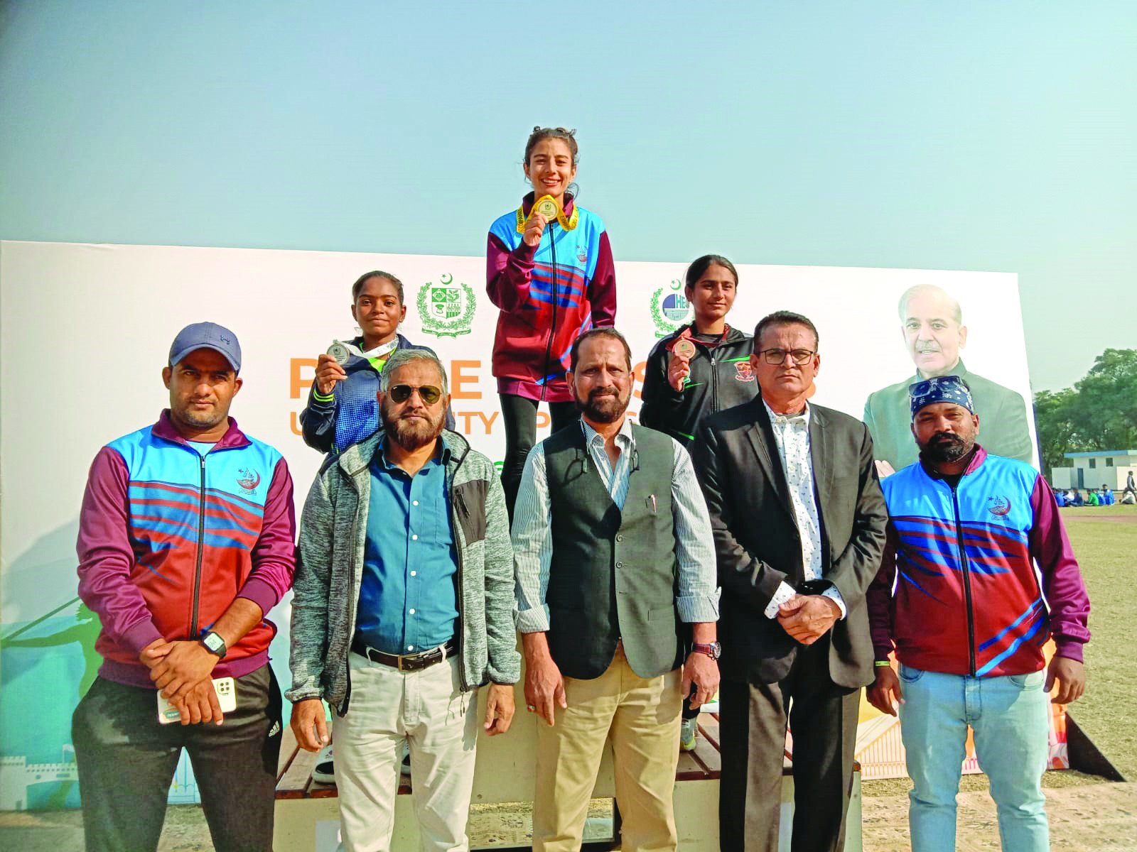 karachi university s girls athletes seen on the podium at the pm sports olympiad ku sports officials are also seen in the picture photo app