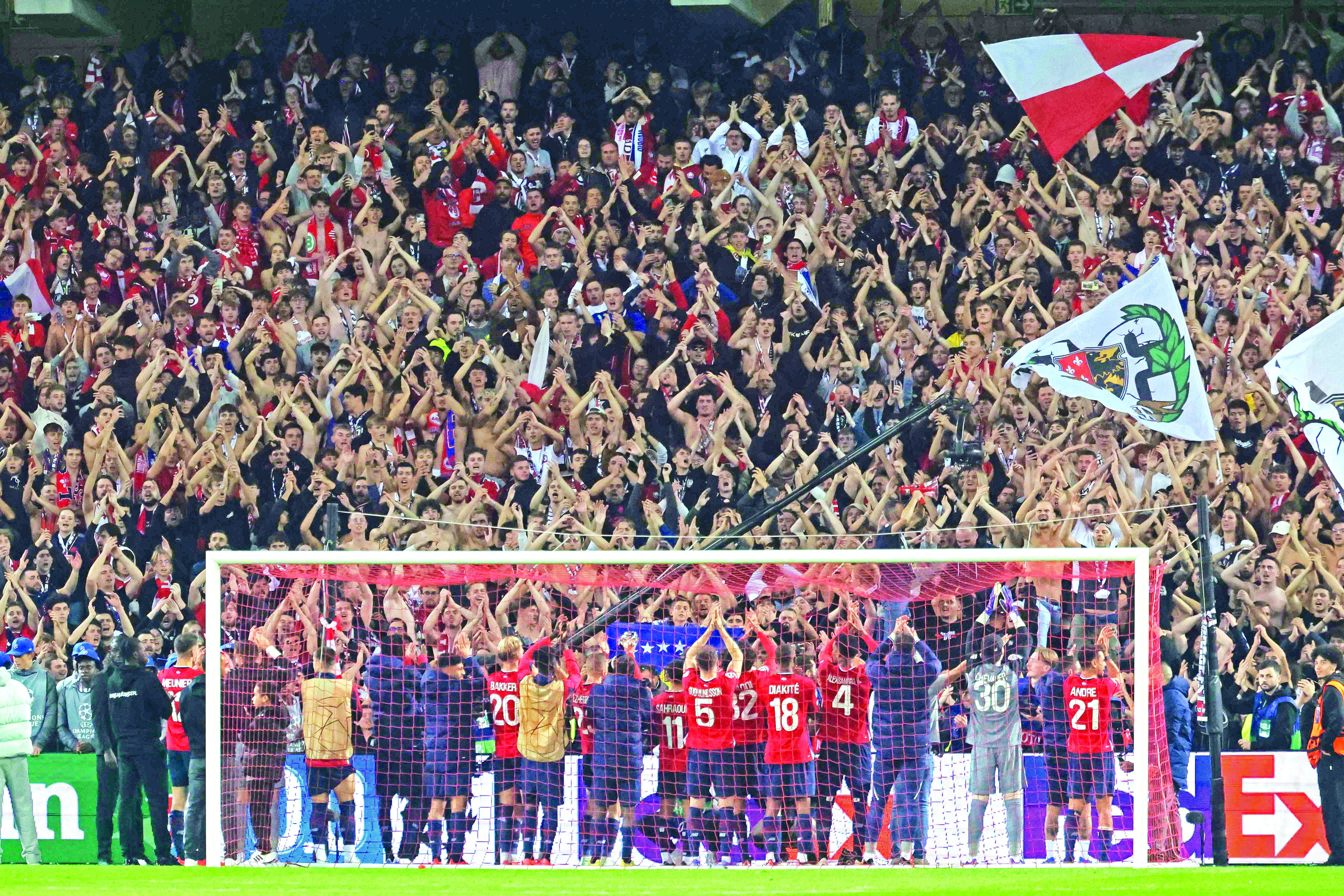 lille s players celebrate with supporters after beating real madrid in uefa champions league match on wednesday night photo afp