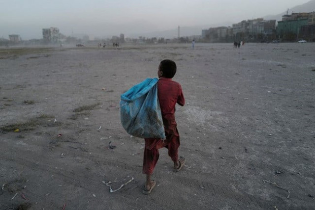 eftekhar 14 carries a bag filled with plastic bottles he collected to be sold as he walks in a playground in kabul afghanistan october 22 2021 photo reuters eftekhar 14 carries a bag filled with plastic bottles he collected to be sold as he walks in a playground in kabul afghanistan october 22 2021 photo reuters
