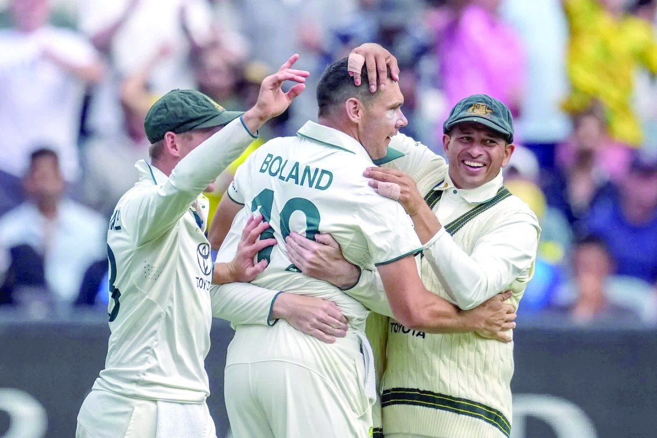 scott boland is mobbed by his teammates after the wicket of virat kohli photo afp