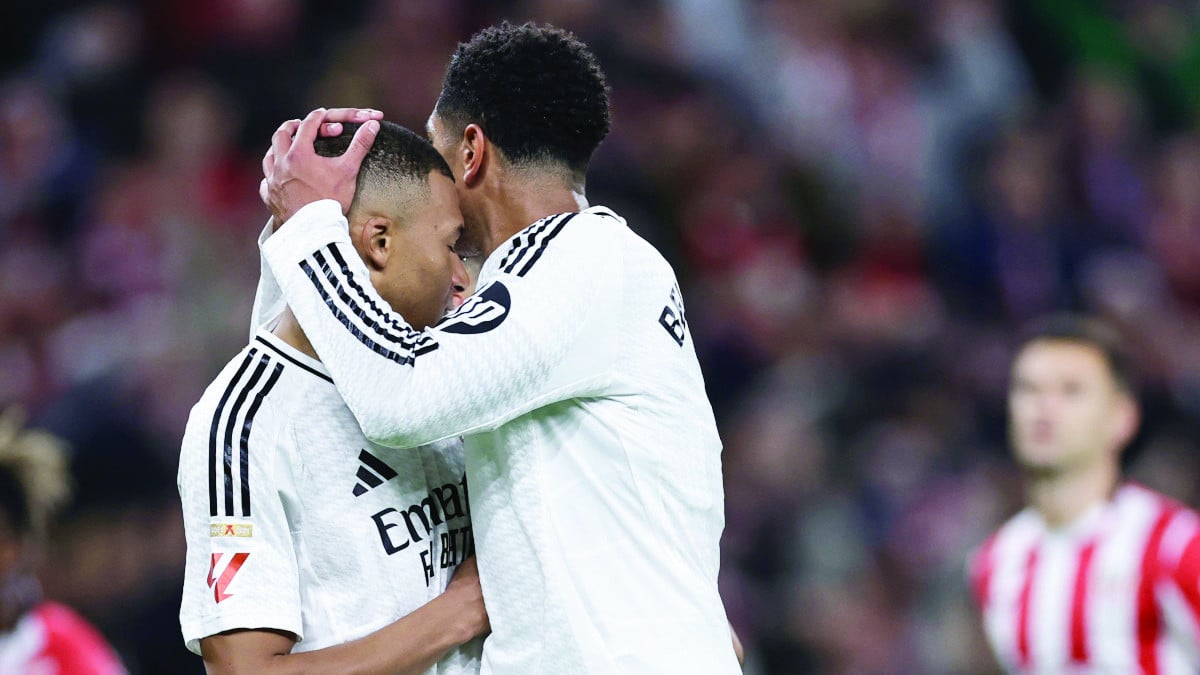 real madrid s french forward kylian mbappe l is comforted by jude bellingham after missing his penalty photo afp