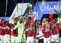 ac milan s davide calabria lifts the trophy as he celebrates with teammates after winning the italian super cup photo reuters