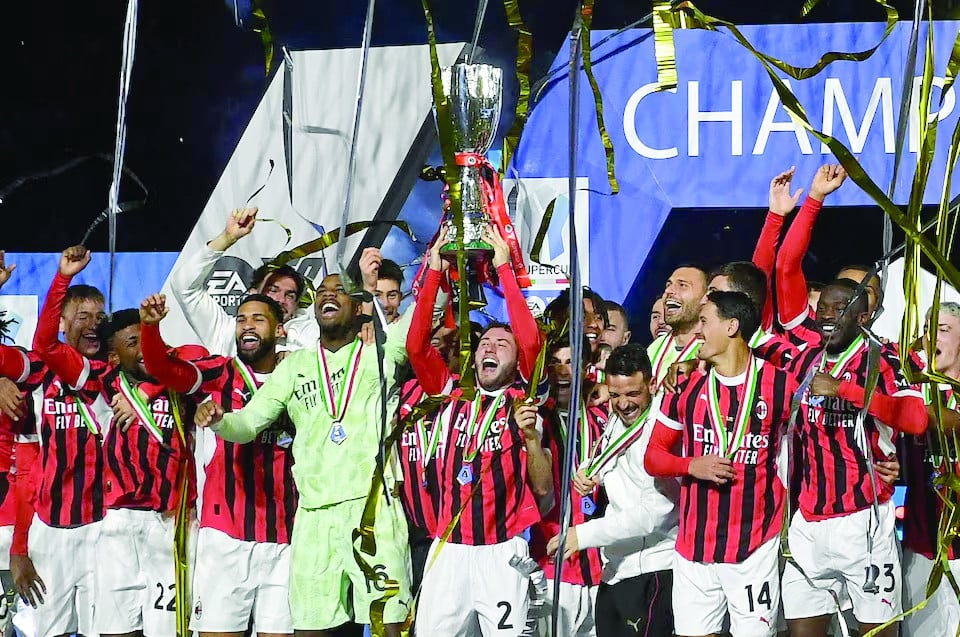 ac milan s davide calabria lifts the trophy as he celebrates with teammates after winning the italian super cup photo reuters