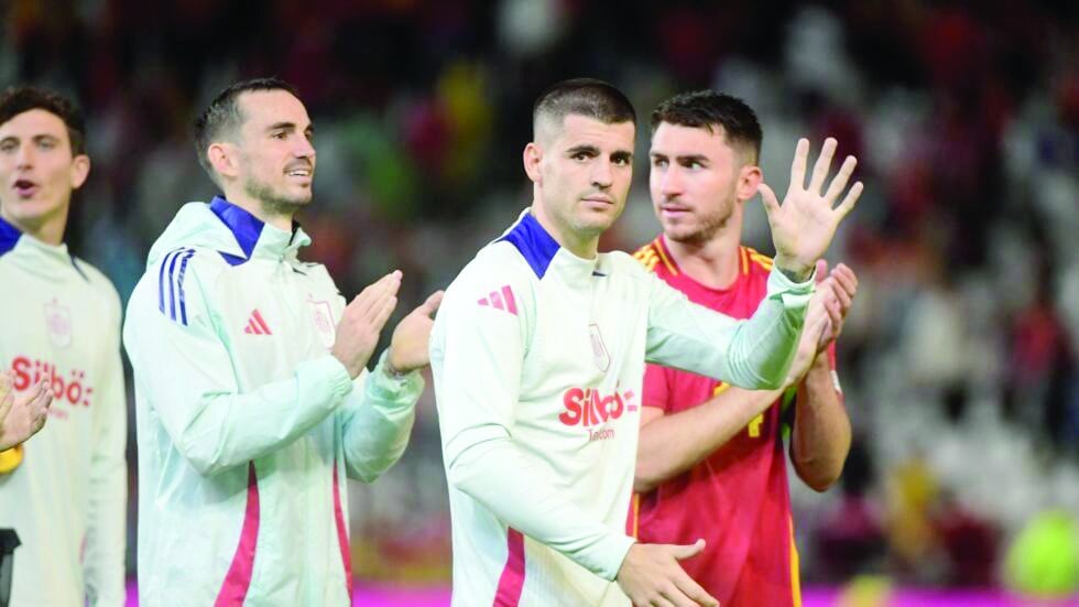 spain s fabian ruiz alvaro morata and aymeric laporte celebrate after beating serbia 3 0 on tuesday photo afp