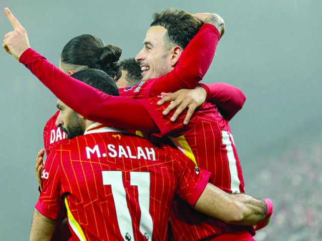 leaders liverpool survive leicester scare