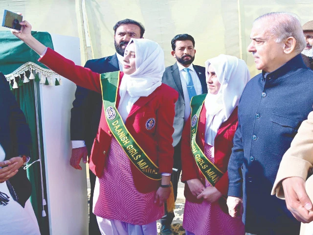 a girl takes a selfie with prime minister shehbaz sharif during his visit to the daanish school in bhimber photo ppi a girl takes a selfie with prime minister shehbaz sharif during his visit to the daanish school in bhimber photo ppi