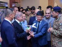 prime minister shehbaz sharif is presented a model of an aircraft by a chinese official at the new gwadar international airport photo inp