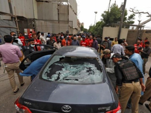 police officers survey a damaged car at the site of an attack at the pakistan stock exchange psx entrance in karachi photo reuters police officers survey a damaged car at the site of an attack at the pakistan stock exchange psx entrance in karachi photo reuters
