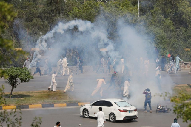 supporters of the pakistan tehreek e insaf pti run with batons amid the tear gas smokes fired by police to prevent them from attending the protest march planned by ousted prime minister imran khan in islamabad may 25 2022 photo reuters supporters of the pakistan tehreek e insaf pti run with batons amid the tear gas smokes fired by police to prevent them from attending the protest march planned by ousted prime minister imran khan in islamabad may 25 2022 photo reuters