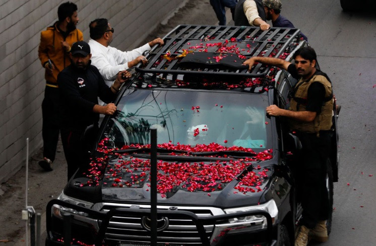 Former Pakistani Prime Minister Imran Khan, waves from the vehicle as he leaves from Lahore to appear before Islamabad High Court, in Lahore, Pakistan March 18, 2023. REUTERS/Akhtar Soomro
