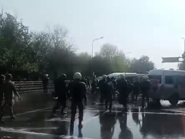 police stand on canal road in lahore near zaman park attacking abandoned vehicles photo pti screengrab police stand on canal road in lahore near zaman park attacking abandoned vehicles photo pti screengrab