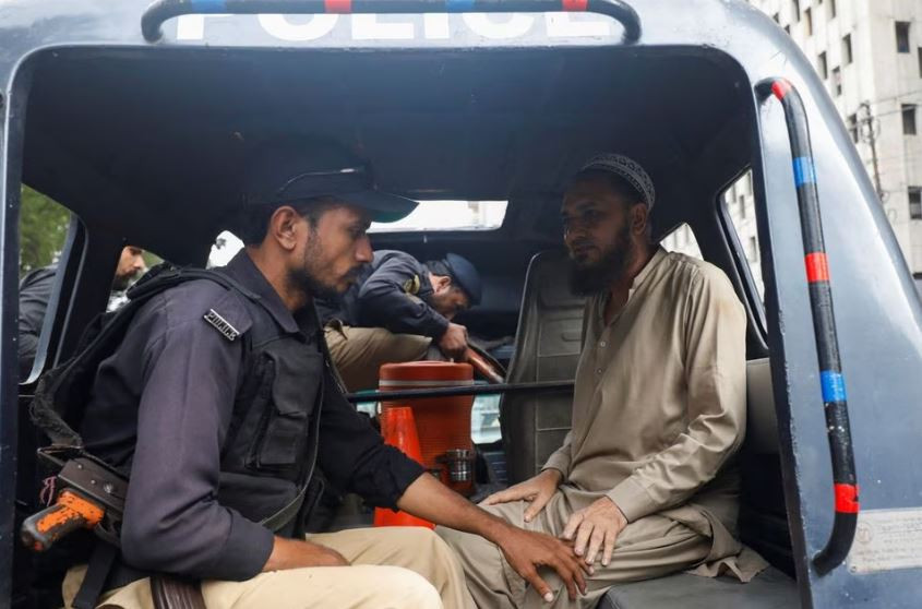 a police officer detains a supporter after he along with others gathered for a protest following the arrest of former prime minister imran khan in karachi photo reuters