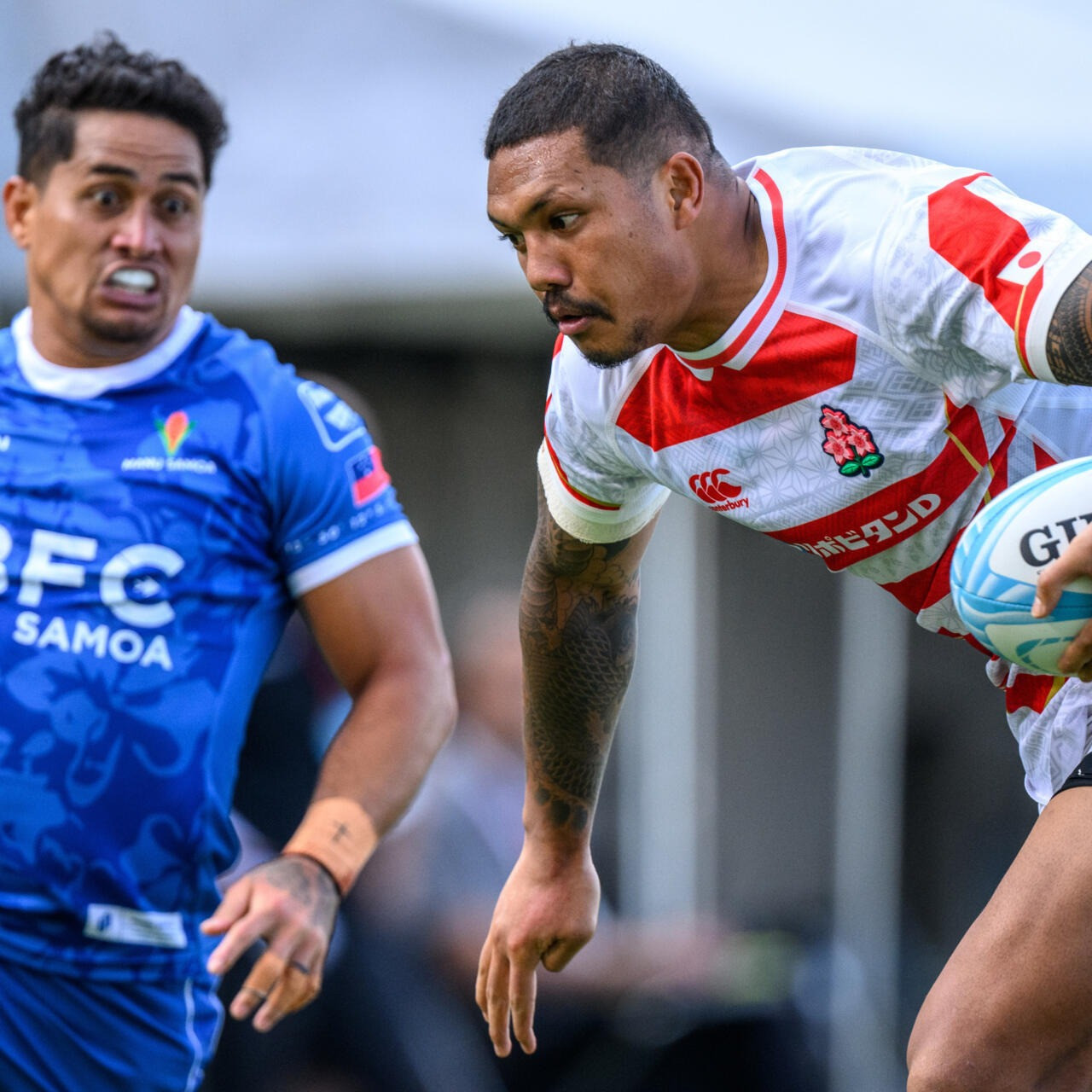 japan s malo tuitama runs at the samoa defence in tokyo photo afp