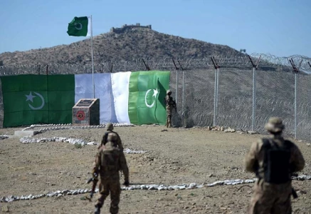 a pakistani soldier keeps vigil at the border fencing along with afghanistan photo afp file