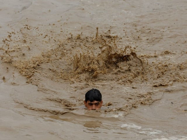 a man swims in flood waters while heading for a higher ground following rains and floods during the monsoon season in charsadda pakistan photo reuters a man swims in flood waters while heading for a higher ground following rains and floods during the monsoon season in charsadda pakistan photo reuters