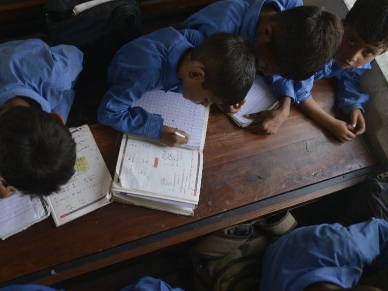 students attend a class at a school on international literacy day in lahore photo afp