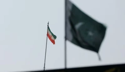 the flag of iran is seen over its consulate building with pakistan s flag in the foreground in karachi pakistan january 18 2024 photo reuters
