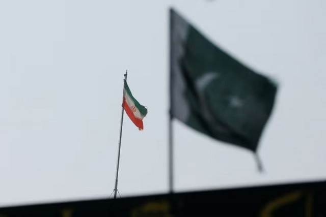 the flag of iran is seen over its consulate building with pakistan s flag in the foreground in karachi pakistan january 18 2024 photo reuters the flag of iran is seen over its consulate building with pakistan s flag in the foreground in karachi pakistan january 18 2024 photo reuters