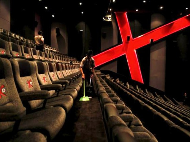 an employee at a cinemaxx theatre cleans up between screenings photo reuters file