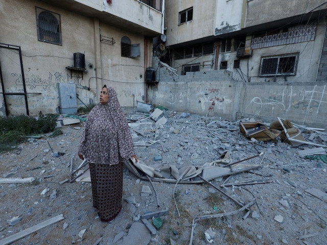 a woman looks on as she stands next to a damaged building where senior commander tayseer al jaabari was killed in israeli strikes in gaza city reuters mohammed salem