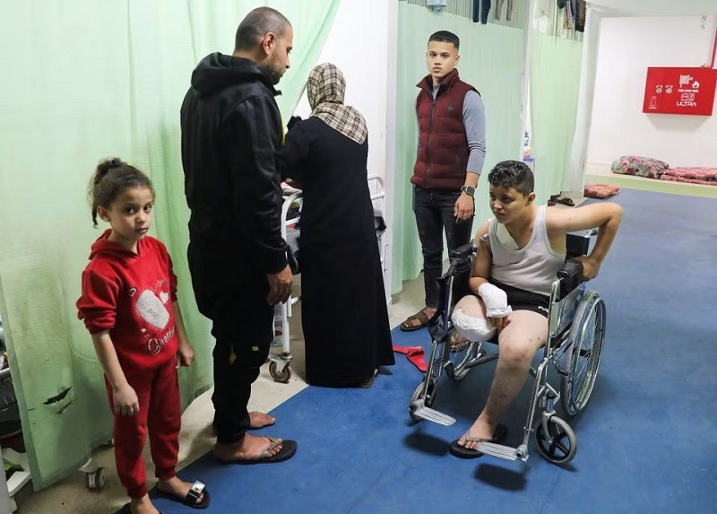Palestinian teenage Ramadan Basal, whose limb was amputated after being wounded in an Israeli strike, sits in a wheelchair as he receives treatment at the European Hospital, in Rafah in the southern Gaza Strip, December 28, 2023. PHOTO: REUTERS