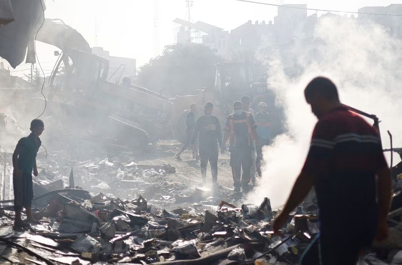 A Palestinian firefighter at the site of Israeli strikes on a residential building in Khan Younis in the southern Gaza Strip, November 7, 2023. PHOTO: REUTERS