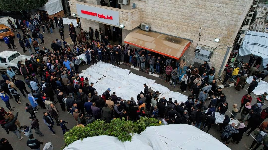 Mourners gather next to the bodies of Palestinians killed in Israeli strikes, at a hospital in the central Gaza Strip, December 25, 2023. PHOTO; REUTERS