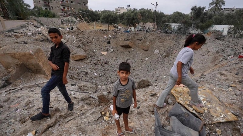 palestinian children near the crater left by an israeli strike in nuseirat in the central gaza strip on june 3 2024 photo afp