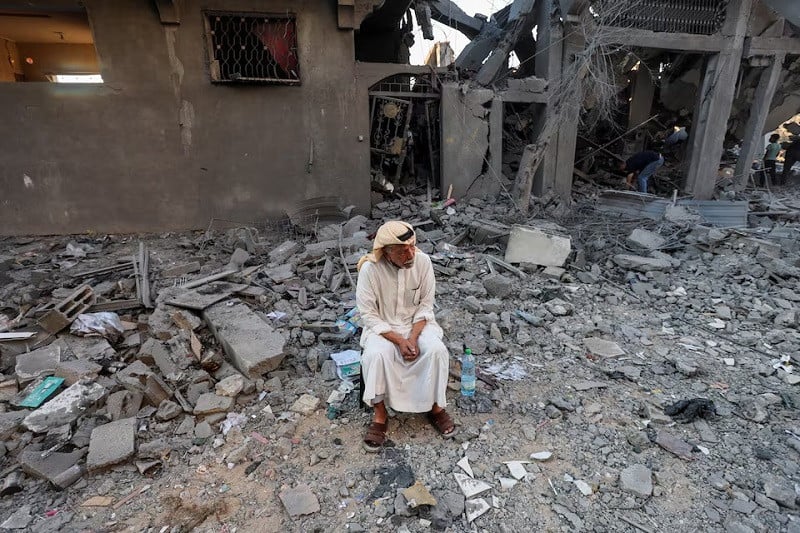 a palestinian man sits outside houses damaged in an israeli strike in deir al balah in the central gaza strip august 7 2024 photo reuters