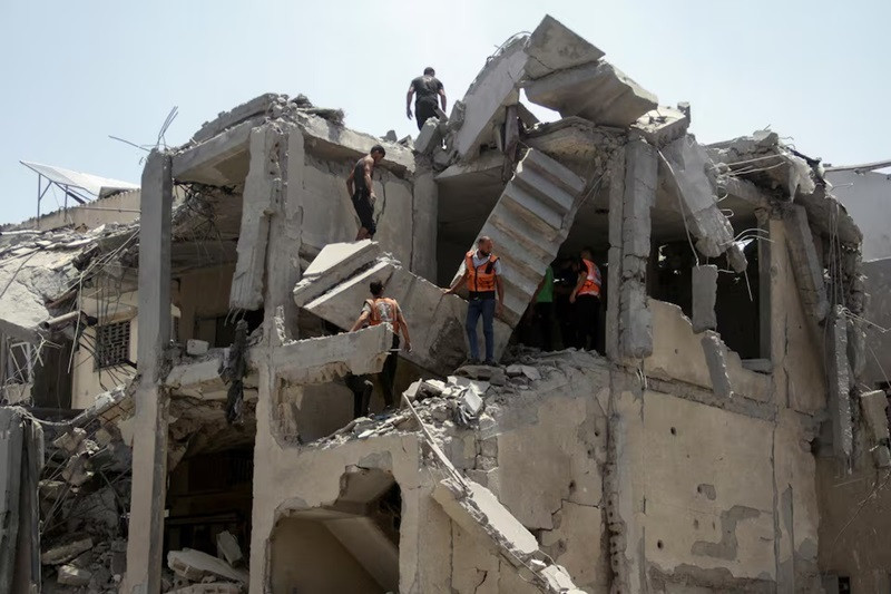 palestinian rescuers work to evacuate casualties from a residential building hit by israeli strikes which destroyed shops at gaza s old city market in gaza city july 4 2024 photo reuters