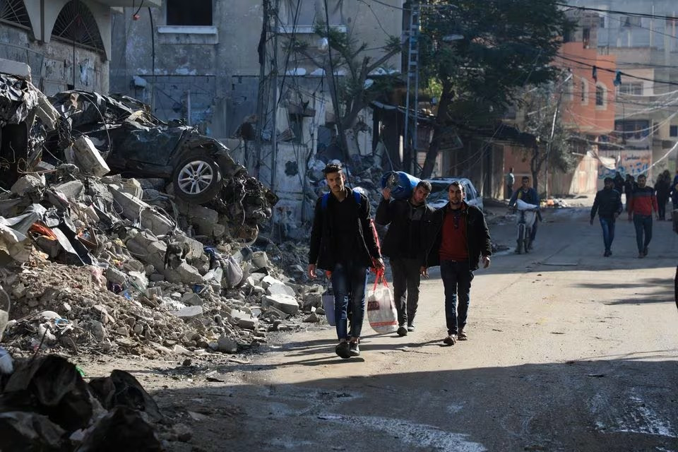 Palestinians carry belongings, as they flee their houses, after they were ordered by the Israeli army to evacuate the area, in Bureij in the central Gaza Strip December 26, 2023. PHOTO; REUTERS
