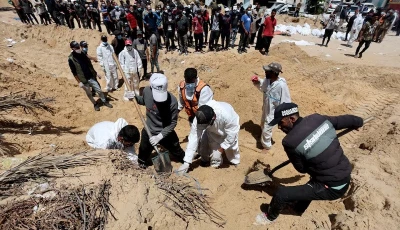 people work to move into a cemetery bodies of palestinians killed during israel s military offensive and buried at nasser hospital in khan younis in the southern gaza strip april 21 2024 photo reuters