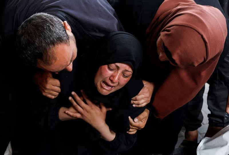 a woman reacts next to the bodies of palestinians killed in israeli strikes in rafah in the southern gaza strip april 16 2024 photo reuters