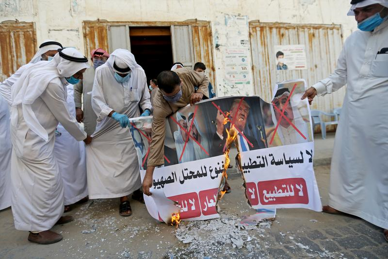palestinians burn pictures depicting israeli prime minister benjamin netanyahu abu dhabi crown prince mohammed bin zayed al nahyan ruler of dubai sheikh mohammed bin rashid al maktoum bahrain s king hamad bin isa al khalifa and us president donald trump during a protest against bahrain s move to normalise relations with israel in the central gaza strip september 12 2020 photo reuters