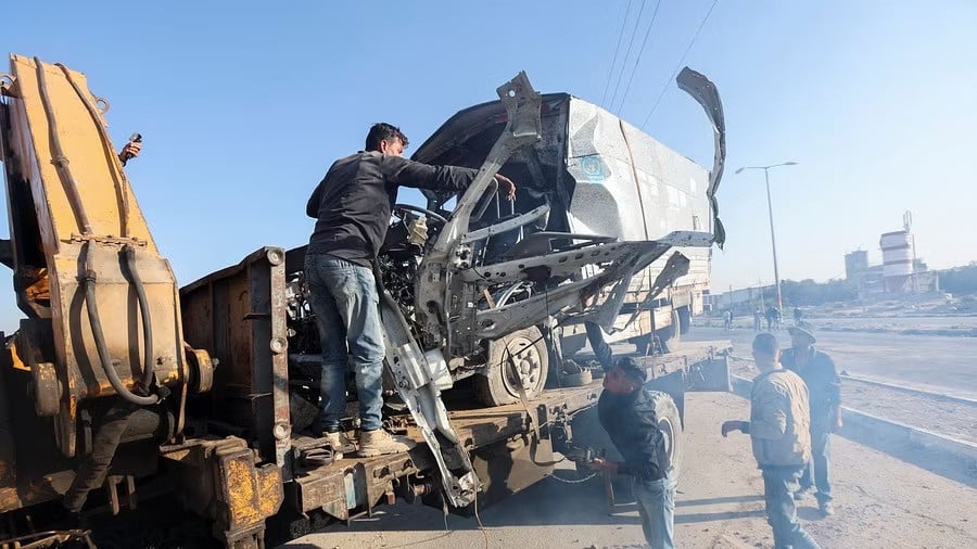 palestinians work to remove an unrwa labelled vehicle after it was hit in an israeli strike in deir al balah in the central gaza strip photo reuters