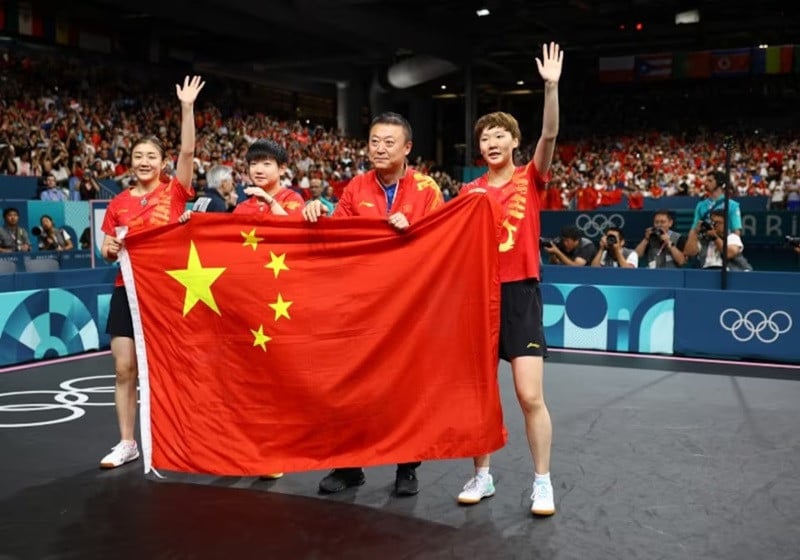 team of china manyu wang yingsha sun meng chen and their coach celebrate after winning their gold medal match against team of japan photo reuters