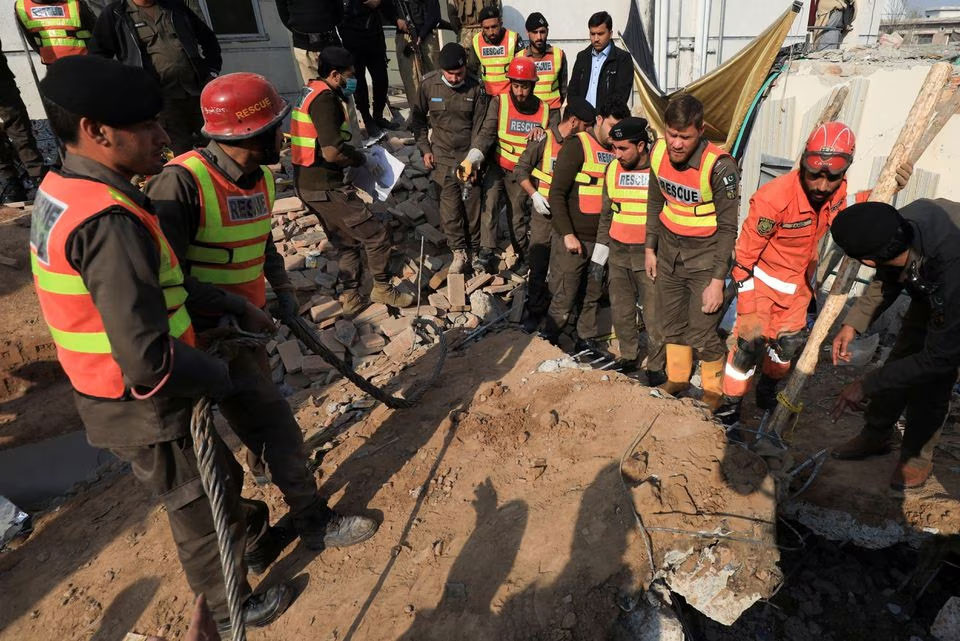 rescue workers clear the rubble as they search for victims after a suicide blast in a mosque in peshawar on jan 31 2023 reuters