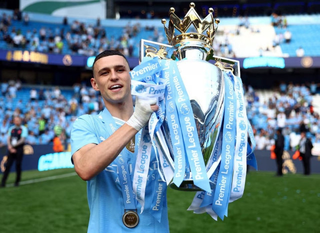 manchester city s phil foden celebrates with the trophy after winning the premier league vs west ham united at etihad stadium manchester britain on may 19 2024 file photo reuters manchester city s phil foden celebrates with the trophy after winning the premier league vs west ham united at etihad stadium manchester britain on may 19 2024 file photo reuters