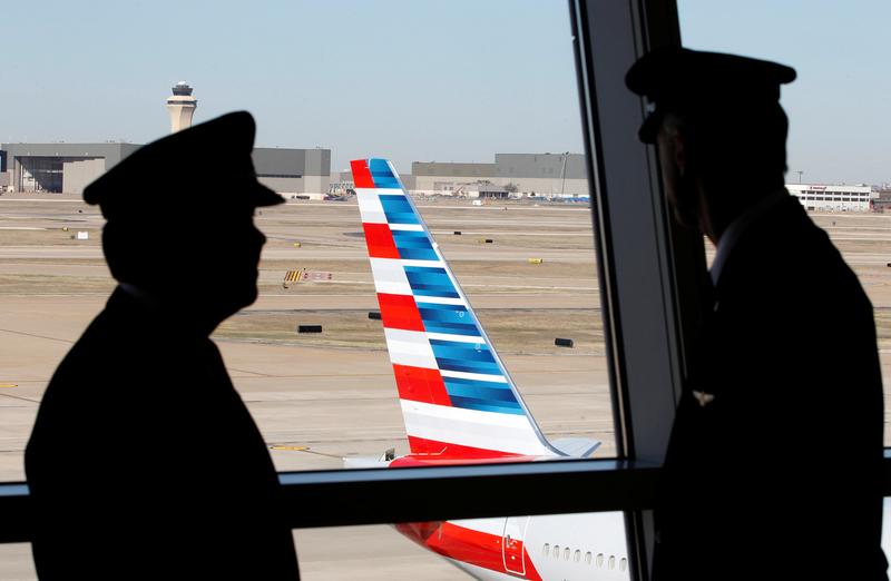 pilots talk as they look at the tail of an american airlines aircraft at dallas fort worth international airport february 14 2013 photo reuters file