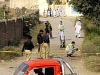 police officials gather evidence from the site of an attack on polio workers in khyber pakhtunkhwa photo file