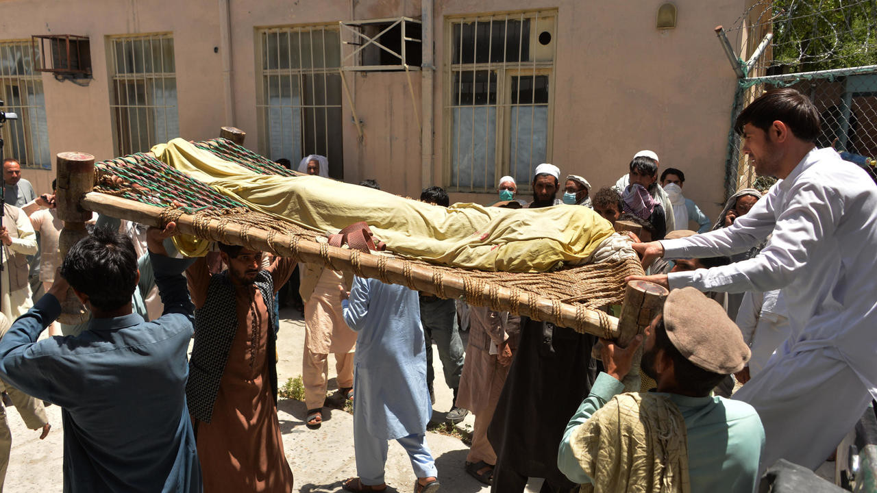 relatives carry the body of a polio worker who was shot dead by gunmen in a string of targeted attacks on vaccinators in afghanistan photo afp