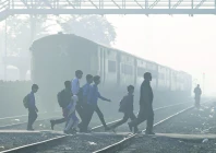 school children walk across a railway track engulfed in dense smog in lahore photo afp school children walk across a railway track engulfed in dense smog in lahore photo afp