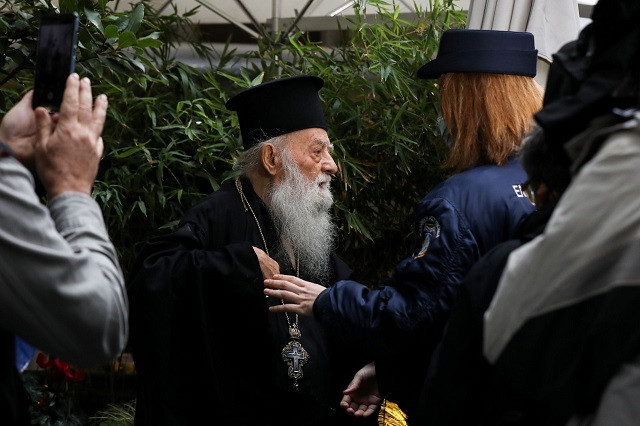 an orthodox priest protests ahead of the arrival of pope francis outside the orthodox archbishopric of greece in athens greece december 4 2021 photo reuters