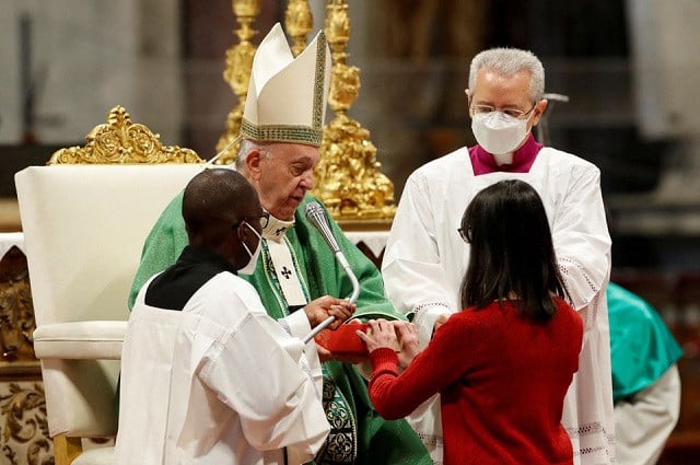 a new lector receives a gospel from pope francis during a holy mass held every year on the third sunday of january to celebrate and study the word of god in st peter s basilica at the vatican january 23 2022 photo reuters