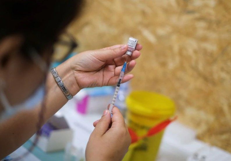 a healthcare worker prepares a dose of the pfizer coronavirus disease covid 19 vaccine at a vaccination centre in seixal portugal september 11 2021 photo reuters