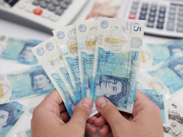 woman holds british pound banknotes in this illustration taken may 30 2022 photo reuters woman holds british pound banknotes in this illustration taken may 30 2022 photo reuters