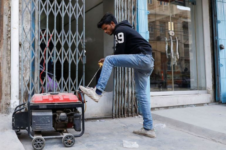 a man starts a generator outside his shop during a country wide power breakdown in karachi january 23 2023 photo reuters akhtar soomro