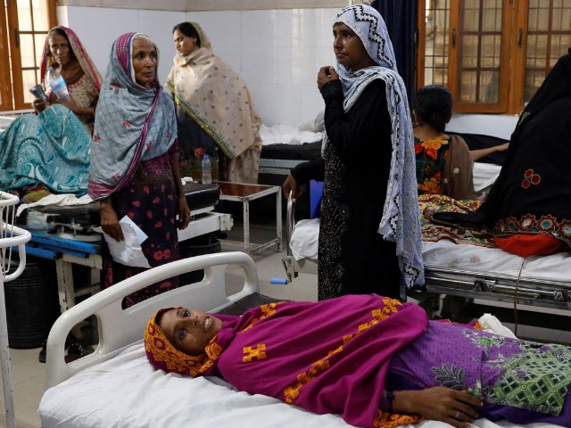 nine months pregnant dilshad allahwarayo 32 lies on a bed while being admitted to a hospital following rains and floods during the monsoon season in sehwan pakistan reuters akhtar soomro