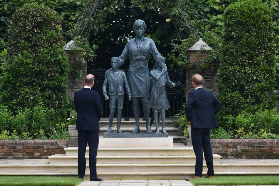 britain s prince william the duke of cambridge and prince harry duke of sussex look at a statue they commissioned of their mother diana princess of wales in the sunken garden at kensington palace london britain july 1 2021 photo reuters